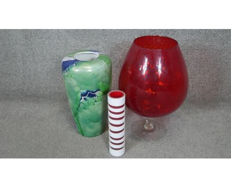 A collection of glass and porcelain. Including a large red Murano glass vase on clear stem, a  white cut to red striped Art G