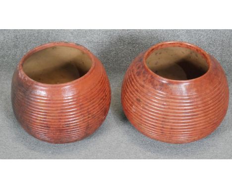 Two large terracotta effect ceramic ridged globe shaped vases. H.28 D.34 