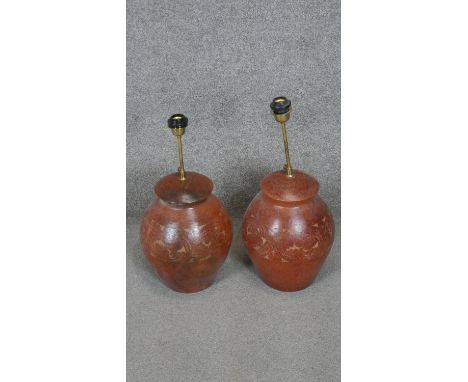 Two floral engraved terracotta effect ceramic table lamps with brass fittings. H.56CM 