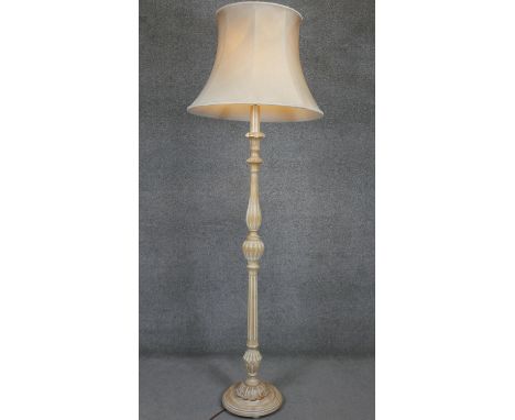 A mid century limed oak standard lamp and shade on fluted baluster column. H.80 D.34 