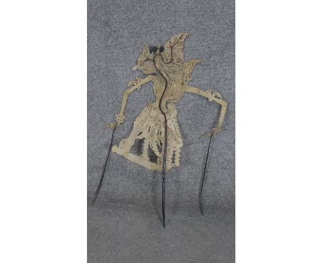 An Indonesian shadow puppet from the island of Java. Made of hide with horn rods. H.74CM 