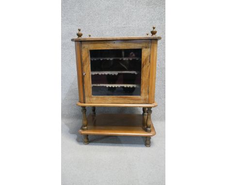 A Victorian walnut and satinwood inlaid music cabinet fitted with sheet music shelves. H. 80 W. 60 D. 38 (Originally forming 