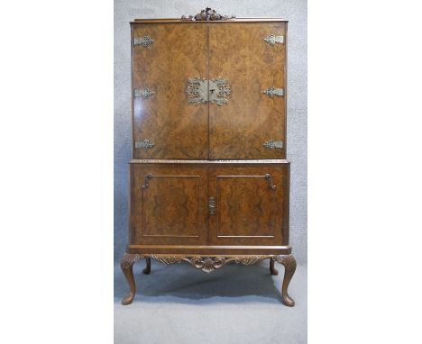 A vintage mid Georgian style burr walnut Epstein drinks cabinet with glazed and fitted interior with interior light raised on