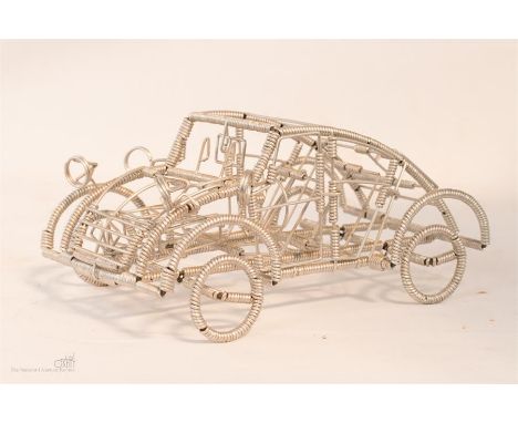 Wire Frame model of Citroen 2CV. Length 20.5cm Height 10cm, together with a book illustrating the design.