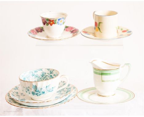 A Cauldon ware floral rimmed coffee cup and saucer, Newhall Coffee can and saucer, Ryde pottery blue decorated trio and a Roy