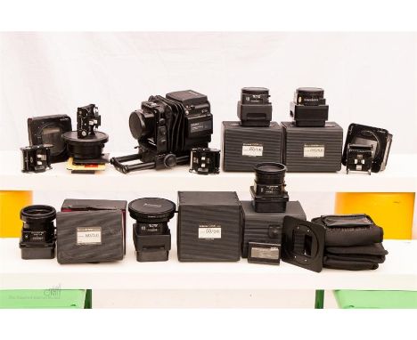 A large format Fujifilm GX680III professional camera with a large quantity of professional lenses and clips, filters, cassett