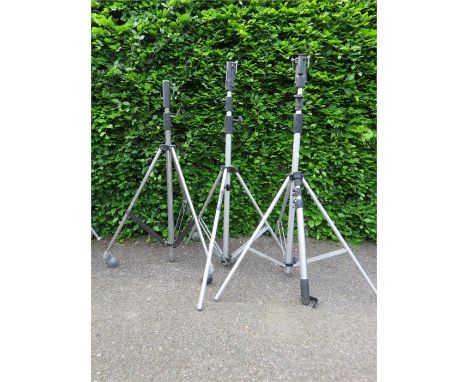 Three photography tripods, including two by Manfrotto.
