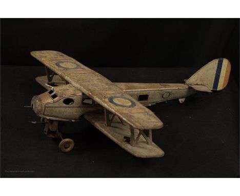 A clockwork painted tin model of Biplane, 46cm wingspan by 51cm.