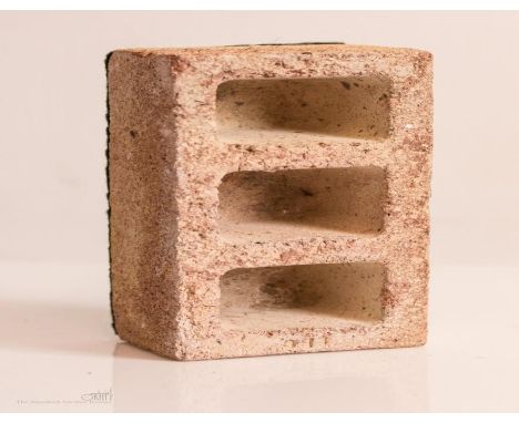 A Porpres model brick paperweight.