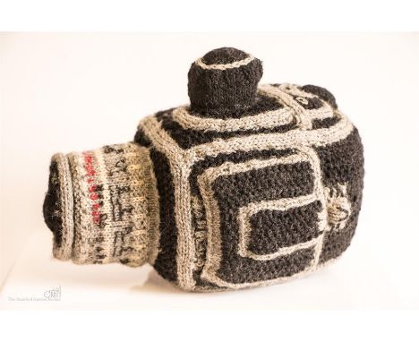 A glass model of a Hasselblad camera and a knitted Hasselblad.