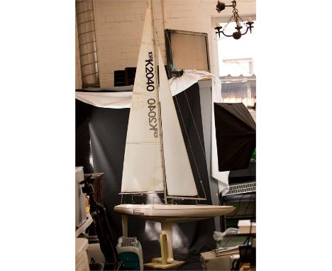 A painted fibreglass remote controlled scale model of a yacht 'Omelette', 269cm high 162cm long, with nylon sail and wooden s