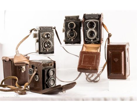 Four Rolleicord twin lens reflex vintage cameras with cases with cased Rolleicord accessories.