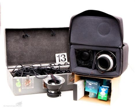 A case of Profoto lighting equipment with one other bag of lighting equipment in a carry bag and various lightbulbs 