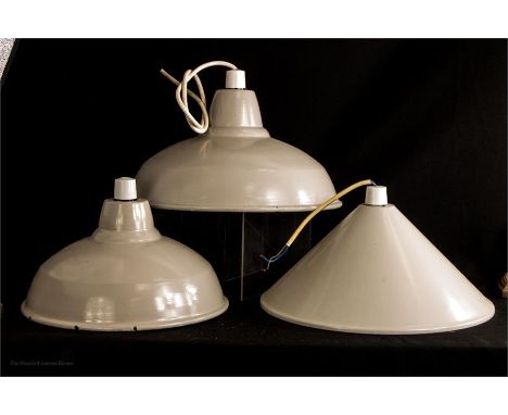 Three industrial design grey enamel pendant light fittings, two of similar profile and one conical. 35.5cm, 30.5cm and 34.5cm