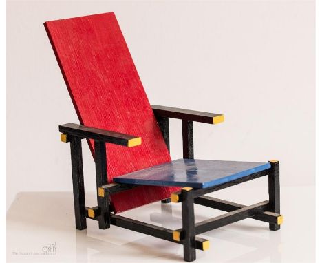 A scale model of The Red and Blue Chair, designed in 1917 by Gerrit Rietveld of the De Stijl art movement.