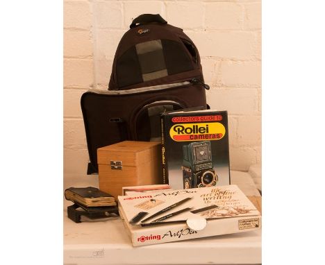 A small Lowe pro rucksack and a Rollei camera book with art pens and filters 