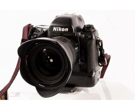 Nikon F5 film camera body with Nikon AF-S Nikkor 12-24mm 1:4GED wideangle lens with petal hood and lens cap.