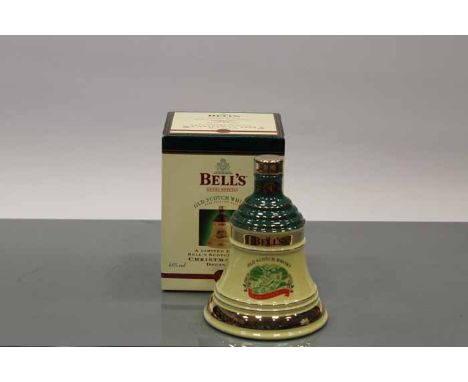 BELL'S CHRISTMAS 1998 BELL
Blended Scotch Whisky in yellow and green  Wade ceramic decanter. 70cl, 40% volume, in carton. CON