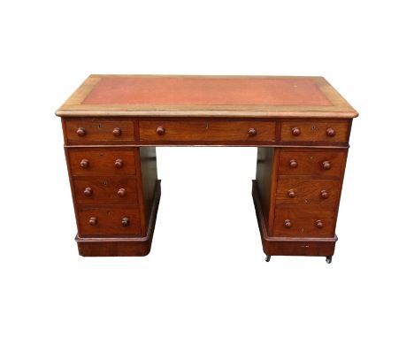 A late Victorian walnut pedestal desk - the rectangular top with writing inset above three frieze drawers, the bases fitted w