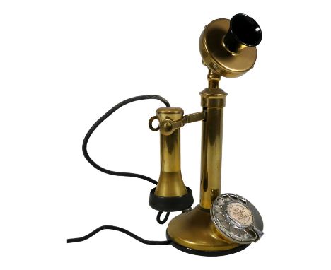 A vintage brass candlestick telephone - with Bakelite fittings, height 32cm.
