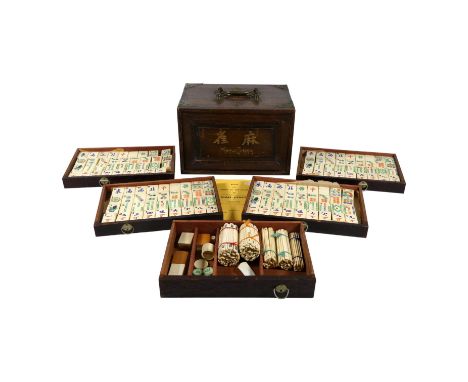 A 20th century mahjong set - circa 1923, in a hardwood box with brass mounts, the tiles of bone and bamboo, width 24cm.