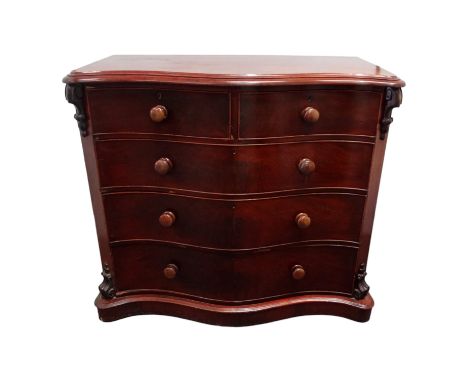 A Victorian mahogany chest of drawers - of serpentine form, the moulded top above an arrangement of two short and three long 