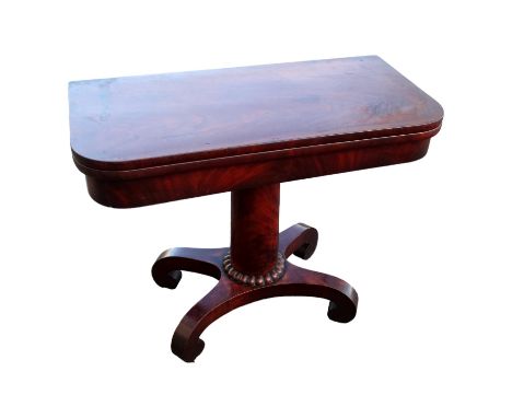 An early Victorian mahogany card table - the rectangular fold-over top above a turned support and plinth base with down-swept