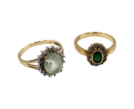 A 9ct gold emerald and diamond ring - the oval central stone within a band of diamonds, size M, 2.6g, together with another d