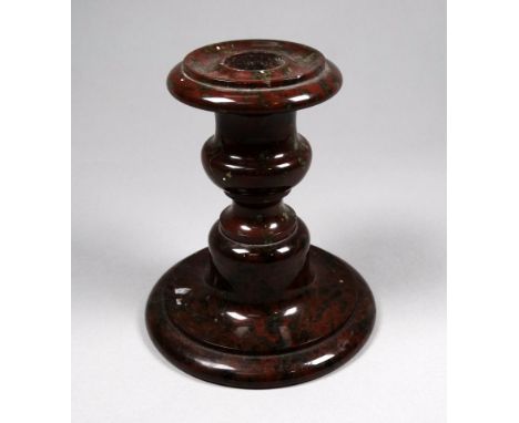A late 19th/early 20th century turned serpentine candlestick - height 11cm. 
