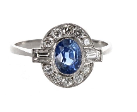 Sapphire and diamond platinum oval cluster ring in the Art Deco manner, the sapphire 1.20ct in a surround of baguette and rou