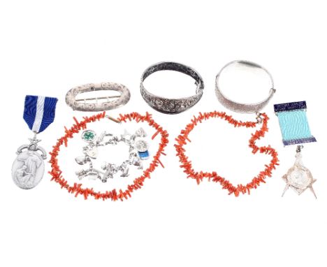 Silver charm bracelet, two silver bangles, two silver Masonic medals, silver buckle and a coral necklet