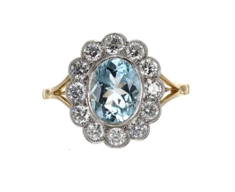 18ct yellow gold and platinum aquamarine and diamond oval cluster ring, the aquamarine 1.40ct in a surround of twelve round b