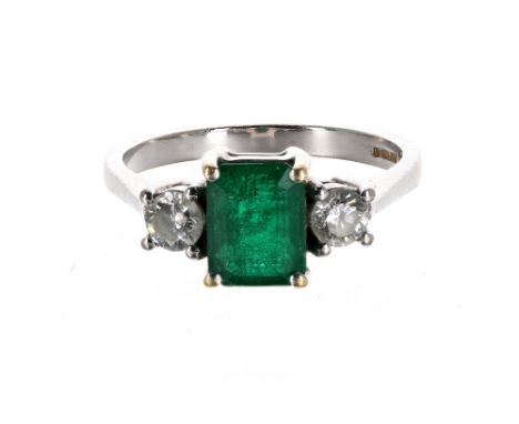 Good modern 18ct white gold emerald and diamond three stone ring, the emerald 1.43ct approx, with two round brilliant-cut dia