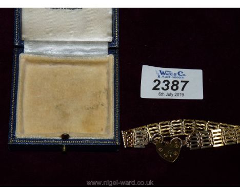 An Oswyn &amp; Co Ltd. presentation case containing a 9ct. gold gate Bracelet having padlock clasp, suitable for a wrist 7" c