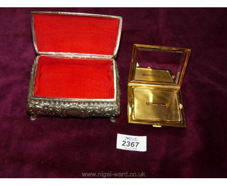 A small jewellery box containing a Christian Dior powder compact.