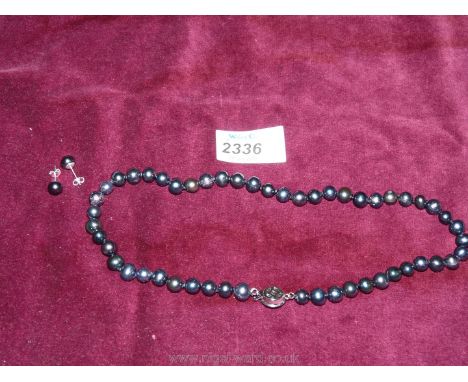 A freshwater pearl black neclace and earrings.