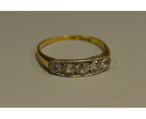 A quintet diamond line ring, old brilliant cut diamonds, platinum crest, 18ct gold shank, stamped 18, 1.9g gross