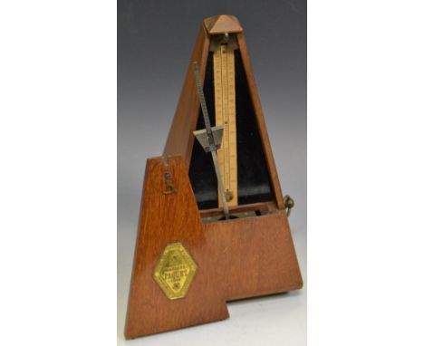 A late 19th/early 20th century French metronome, lozenge shaped cartouche embossed in relief 'Maelzel Paquet'