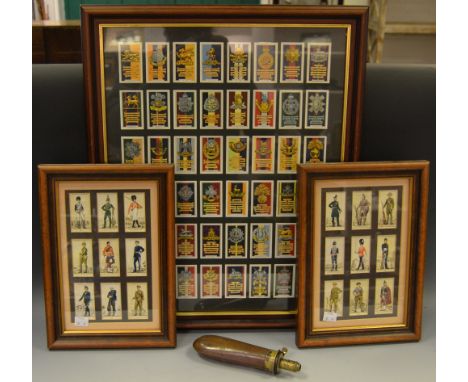 A 19th century bag shaped powder flask; cigarette cards, framed - army badges and uniforms.