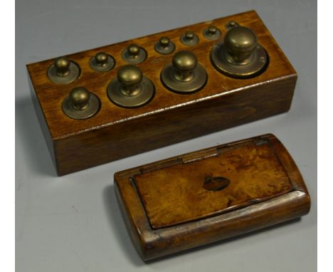 An English walnut snuff box with walnut lining; a set of portal scale weights