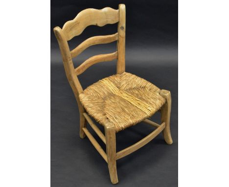 A child's West Country elm ladder back chair,  with raffia seat