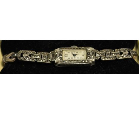 A silver and marcasite lady's cocktail watch, oblong white dial Roman numerals, Swiss manual movements part cord bracelet