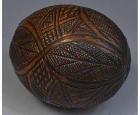 A 19th century carved coconut 'bug bear' flask, 13cm long