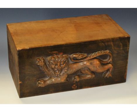 A hardwood corbel or architectural section, carved in relief with a lion passant, 27.5cm wide