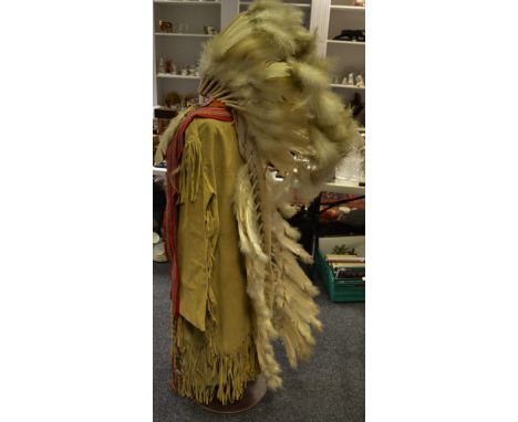 A native American Indian head dress, jacket and trousers and sash