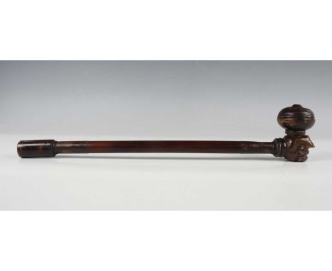 A South-east Asian cane, brass and soapstone opium pipe, 20th century, the soapstone bowl carved in the form of a hand, lengt