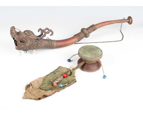A Tibetan copper and brass Buddhist ritual dragon horn, 20th century, with embossed decoration, length 50cm, together with a 
