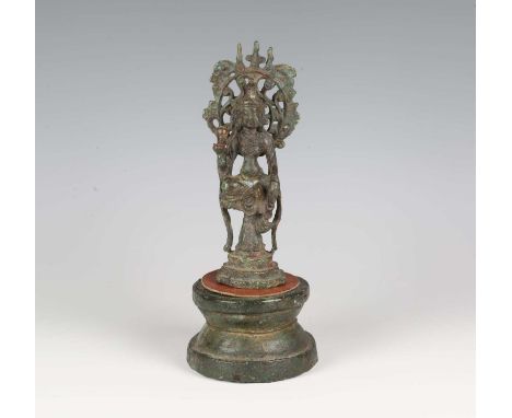 A Chinese bronze figure of Guanyin, probably Tang dynasty, with verdigris patina, modelled seated in lalitasana on a lotus mo