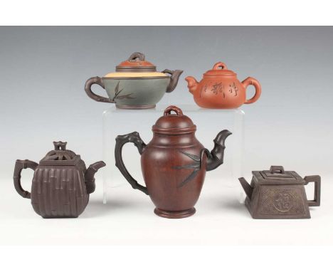 A group of five Chinese Yixing stoneware teapots and covers, 20th century and later, including a dark brown faux bamboo mould