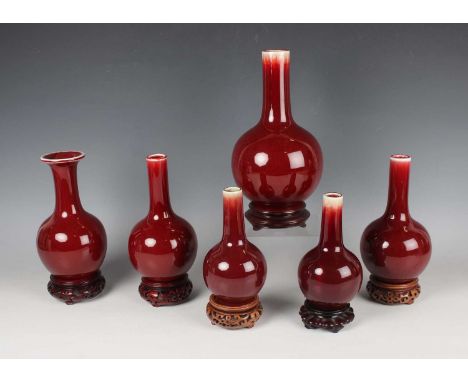 A group of six Chinese sang-de-boeuf glazed porcelain vases, late 20th century, comprising two pairs of bottle vases, heights